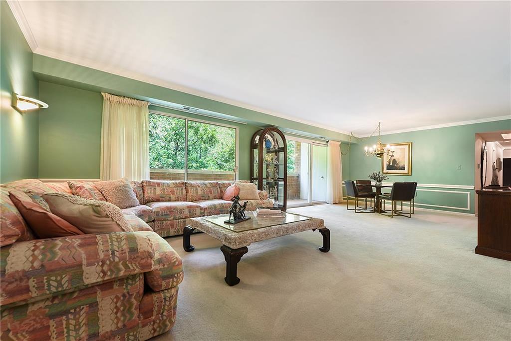 300 Fox Chapel Road, Unit 405 Pittsburgh, PA 15238 - Photo 7 of 30 a living room with furniture and a large window