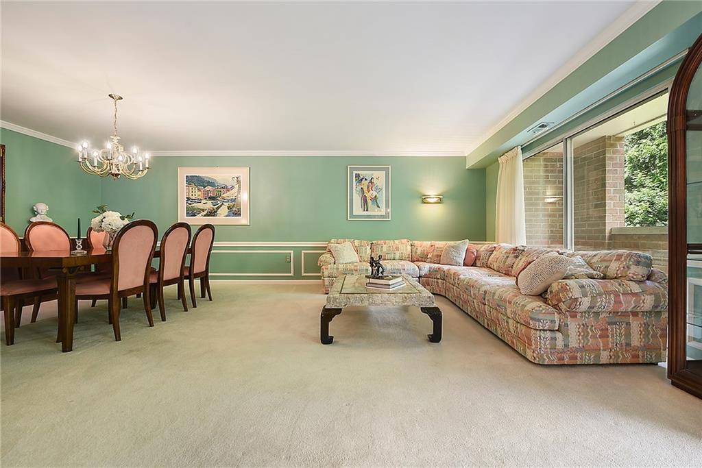 300 Fox Chapel Road, Unit 405 Pittsburgh, PA 15238 - Photo 8 of 30 a living room with furniture and a large window