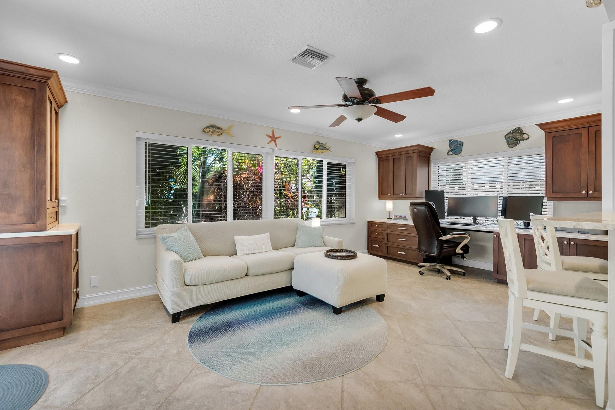 548 Northwest 55th Street Boca Raton, FL 33487 - Photo 11 of 33 a living room with furniture large window and flat screen tv