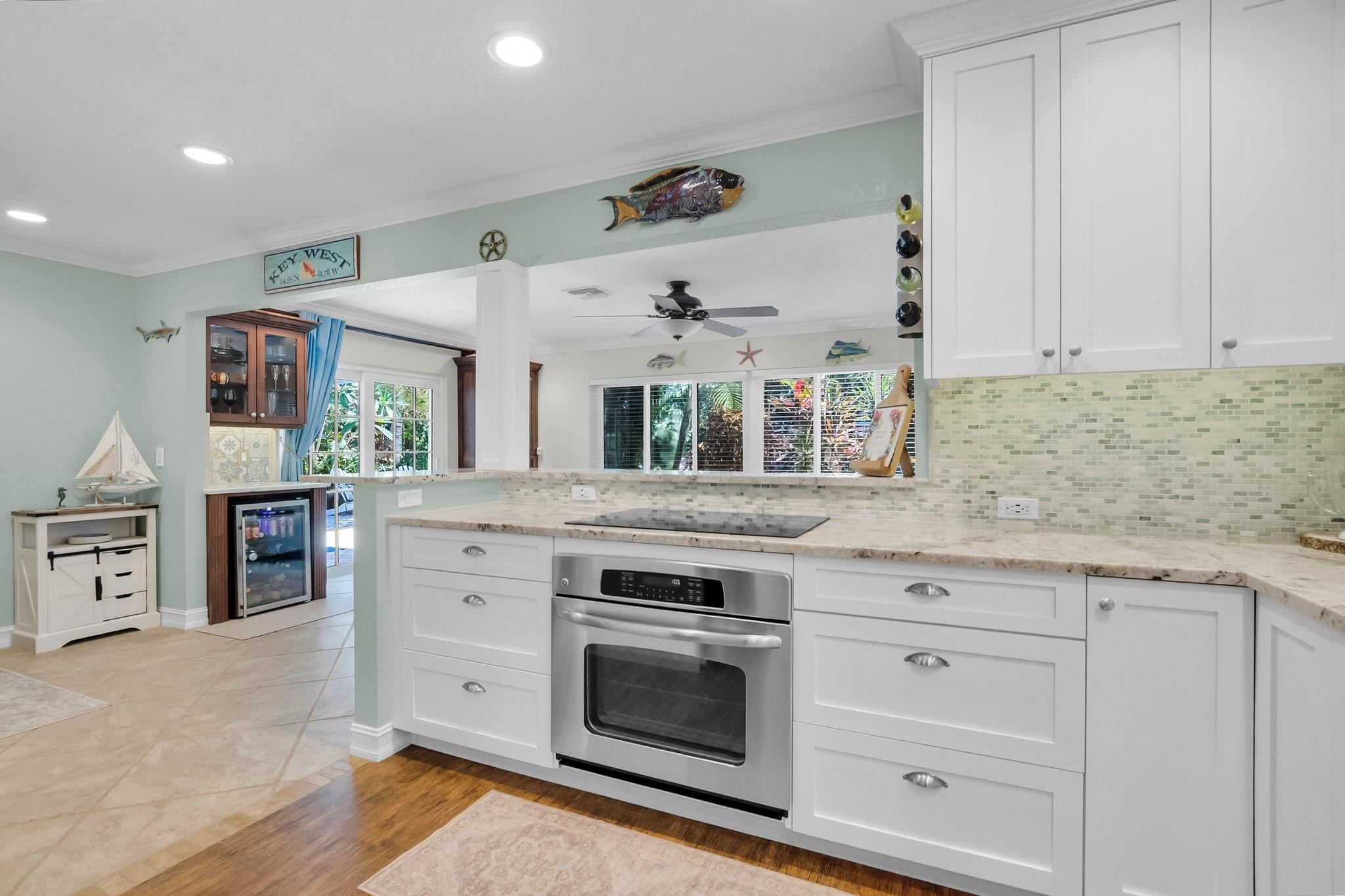 548 Northwest 55th Street Boca Raton, FL 33487 - Photo 16 of 33 a kitchen with granite countertop white cabinets and appliances