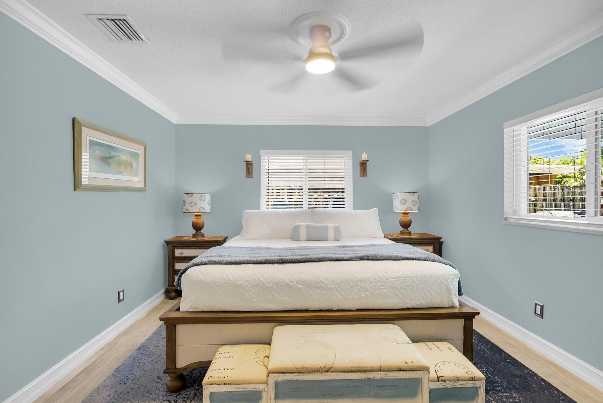 548 Northwest 55th Street Boca Raton, FL 33487 - Photo 20 of 33 a bedroom with a bed and a chandelier