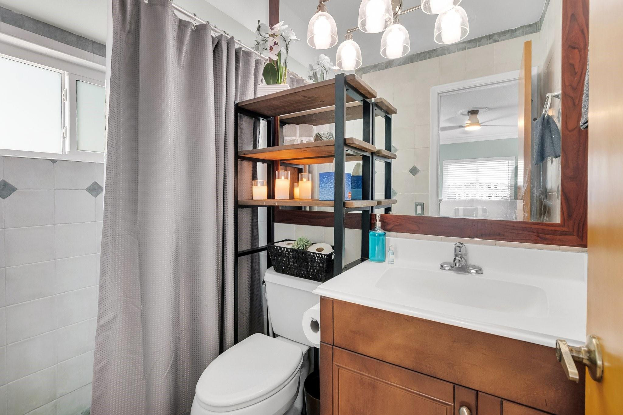 548 Northwest 55th Street Boca Raton, FL 33487 - Photo 21 of 33 a bathroom with a sink a toilet and shower curtain