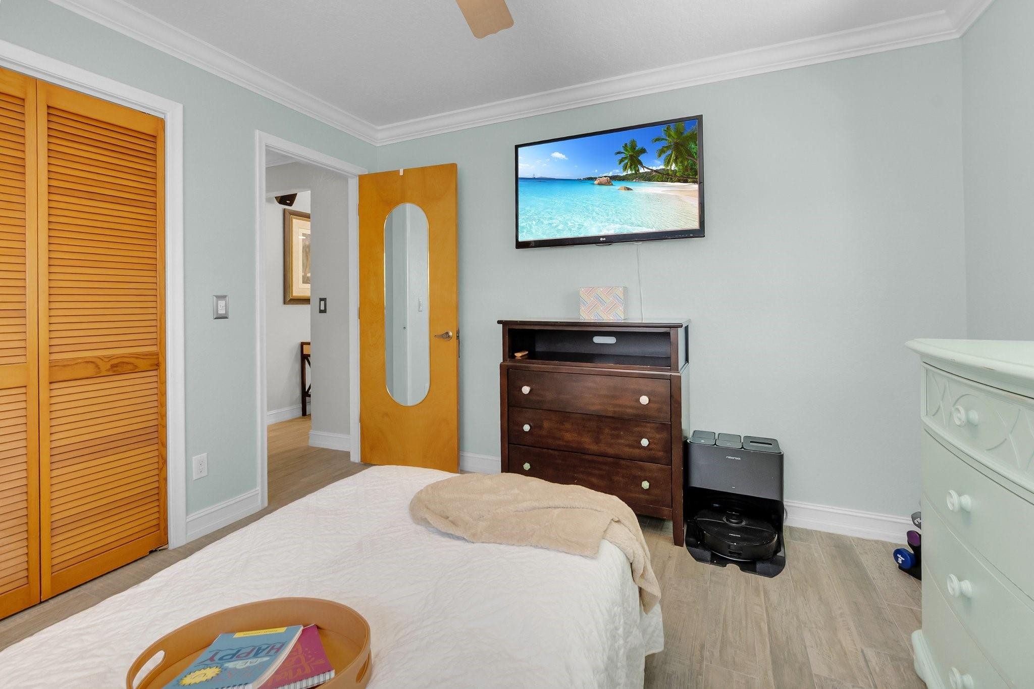548 Northwest 55th Street Boca Raton, FL 33487 - Photo 24 of 33 a bedroom with a bed and a dresser