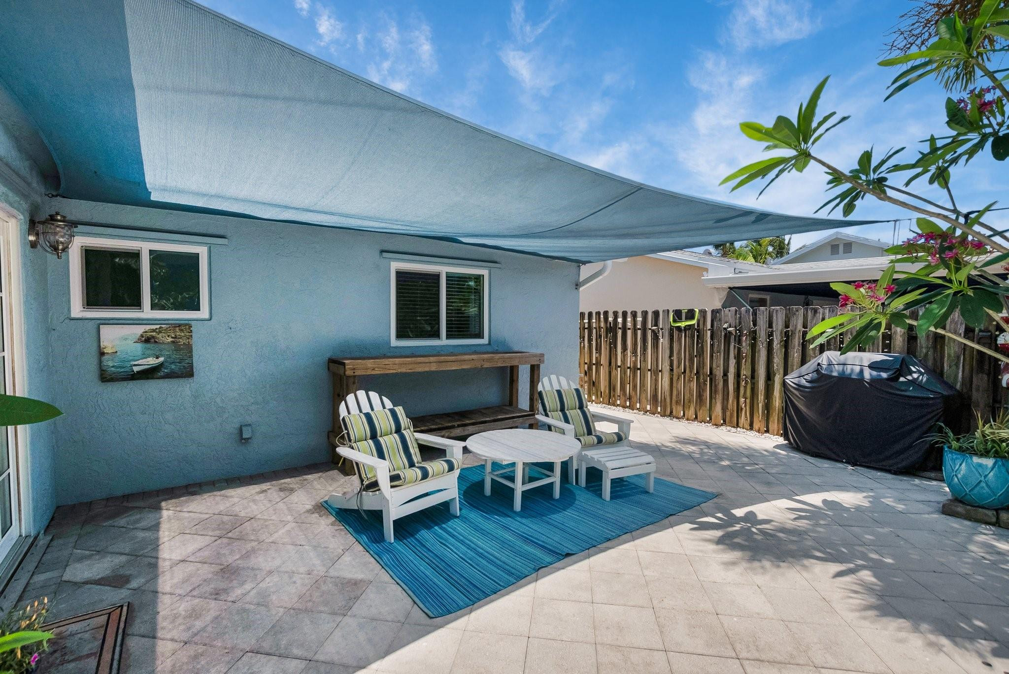 548 Northwest 55th Street Boca Raton, FL 33487 - Photo 27 of 33 a patio with glass top table and chairs