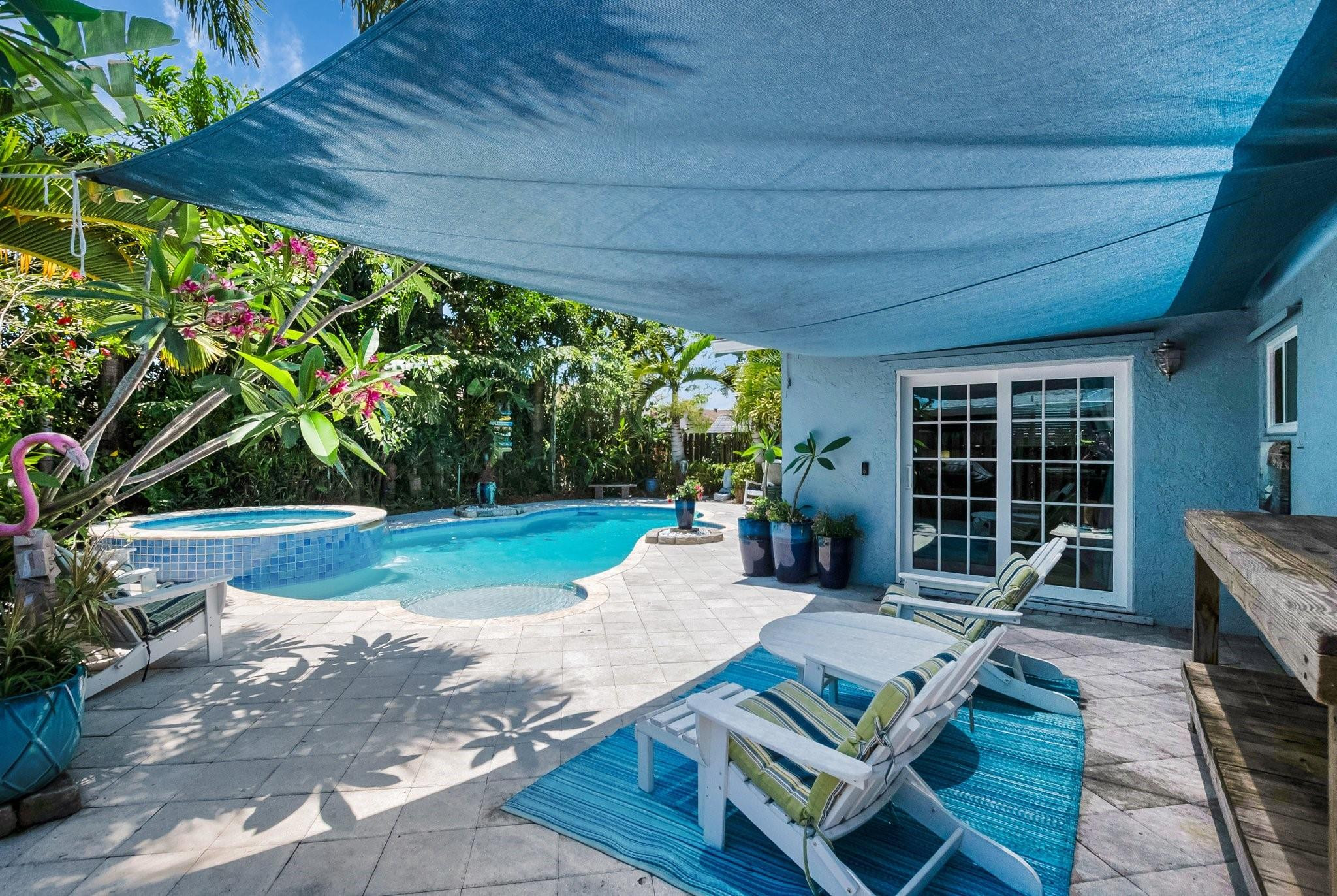 548 Northwest 55th Street Boca Raton, FL 33487 - Photo 28 of 33 a view of a patio with table and chairs barbeque potted plants and large tree