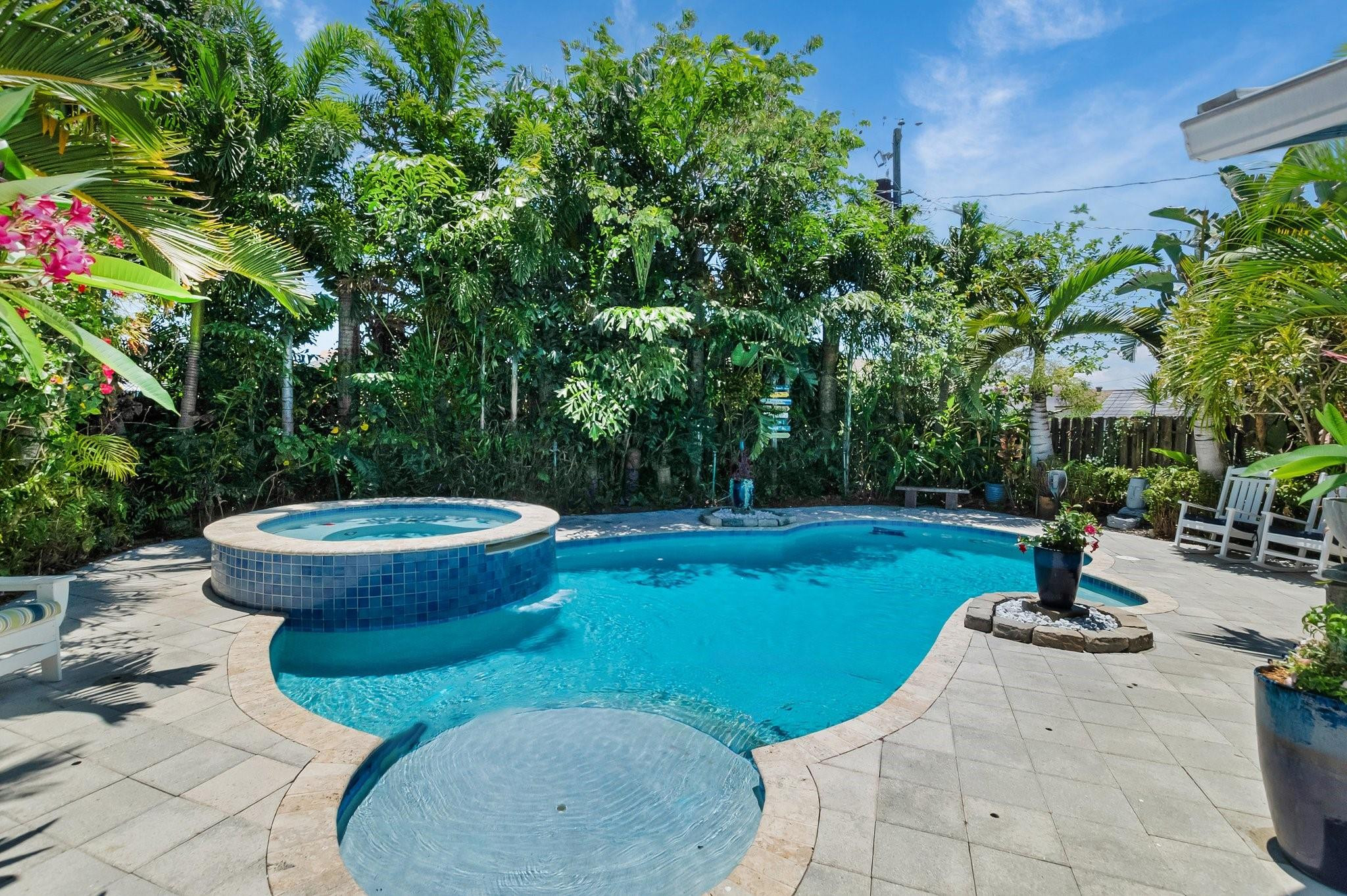 548 Northwest 55th Street Boca Raton, FL 33487 - Photo 29 of 33 a view of a backyard with fountain plants and trees