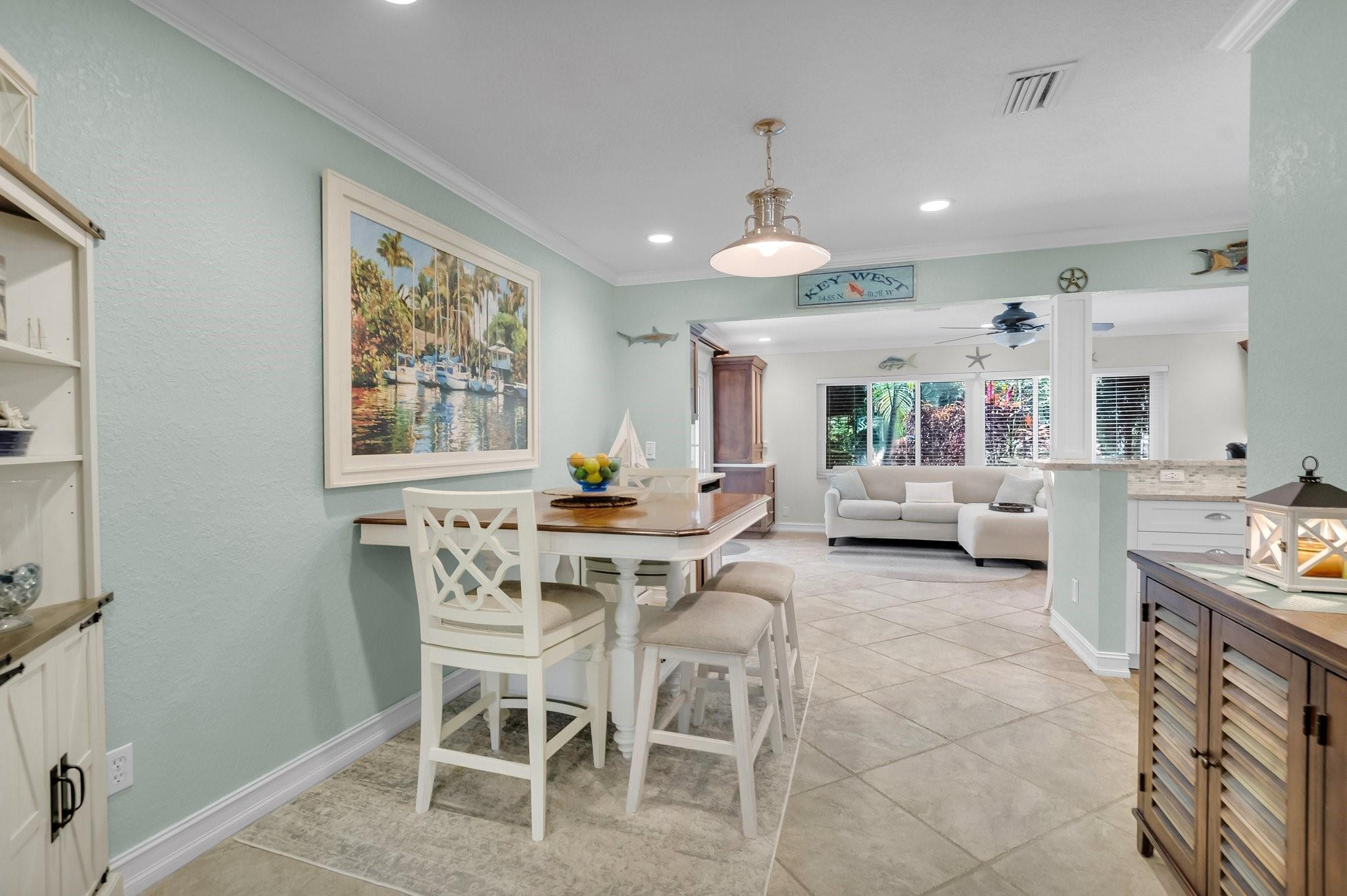 548 Northwest 55th Street Boca Raton, FL 33487 - Photo 8 of 33 a view of a dining room with furniture and a chandelier