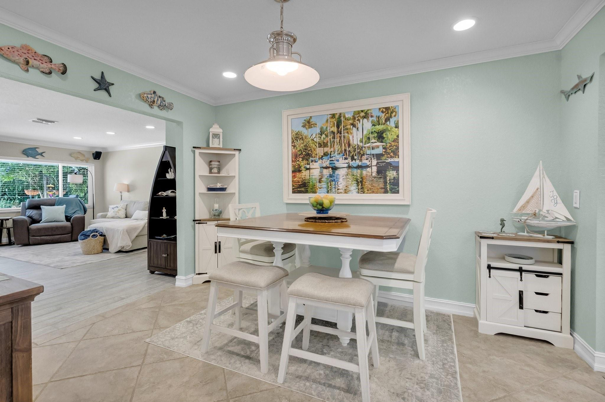 548 Northwest 55th Street Boca Raton, FL 33487 - Photo 9 of 33 a view of a dining room with furniture window and wooden floor