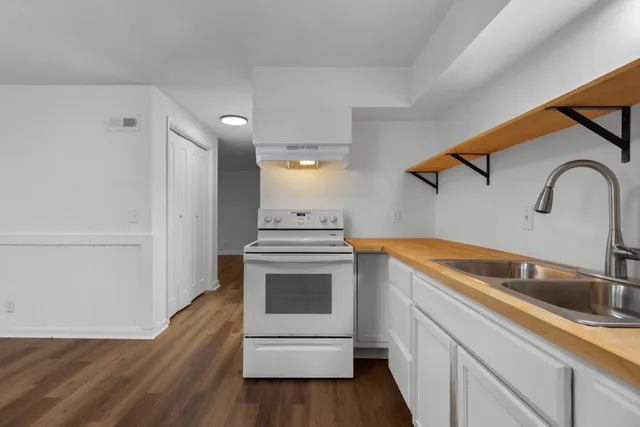 a kitchen with a sink and a stove top oven
