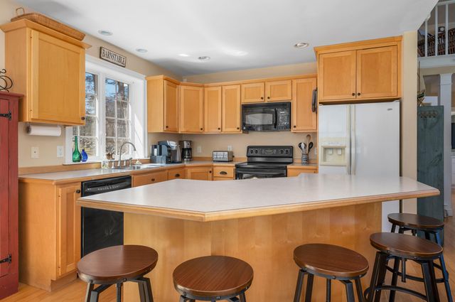 a porch with a bench next to a yard