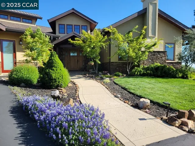 a front view of a house with yard and garage