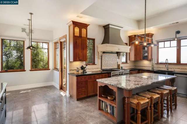 a bathroom with a granite countertop double vanity sink and mirror