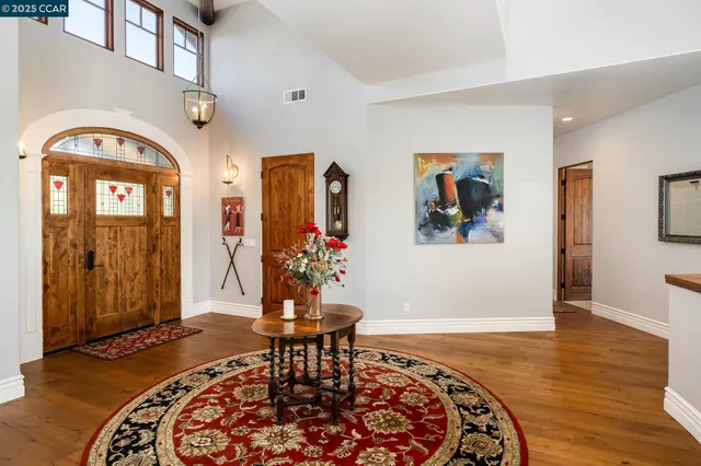 a view of a dining room with furniture wooden floor and chandelier