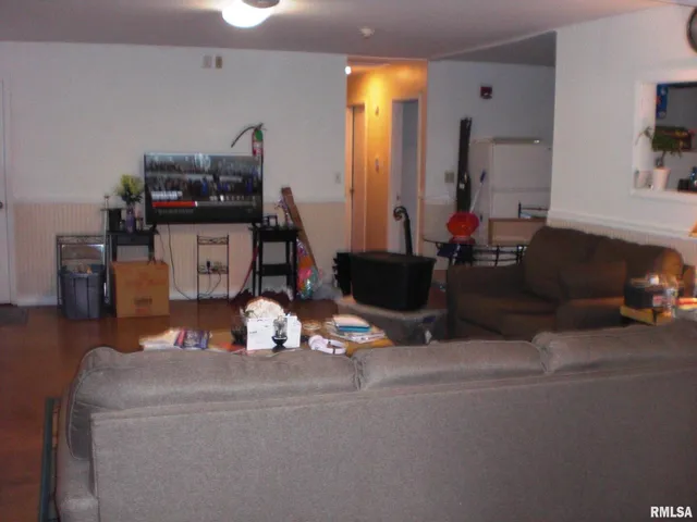 a living room with furniture and a mirror