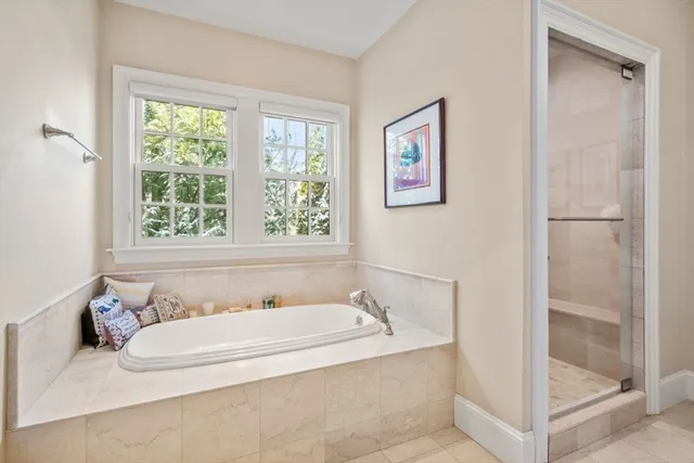 a bathroom with bathtub and window