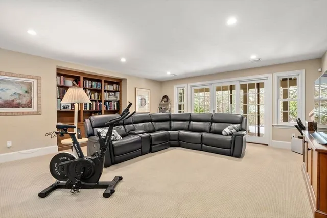 a living room with furniture a rug and a large window