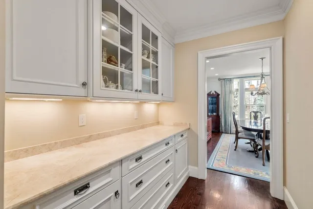 a view of an entryway with wooden floor and cabinet