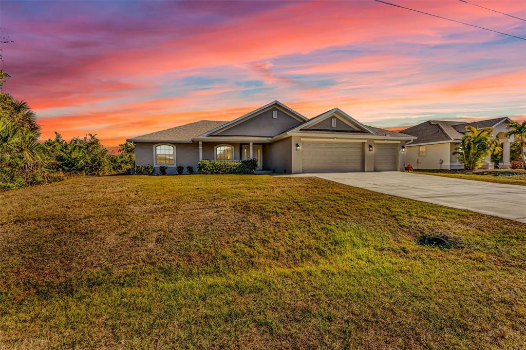 9500 Singer Circle Port Charlotte, FL 33981 - Photo 2 of 60 a front view of a house with a yard