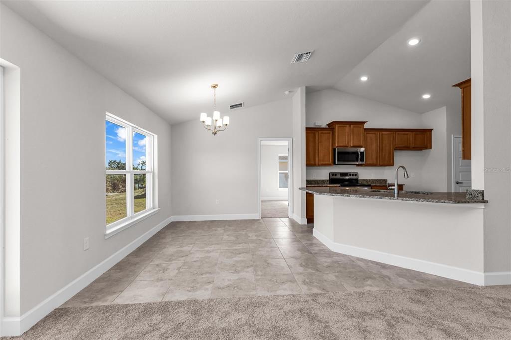 9500 Singer Circle Port Charlotte, FL 33981 - Photo 23 of 60 a view of a kitchen with microwave and cabinets