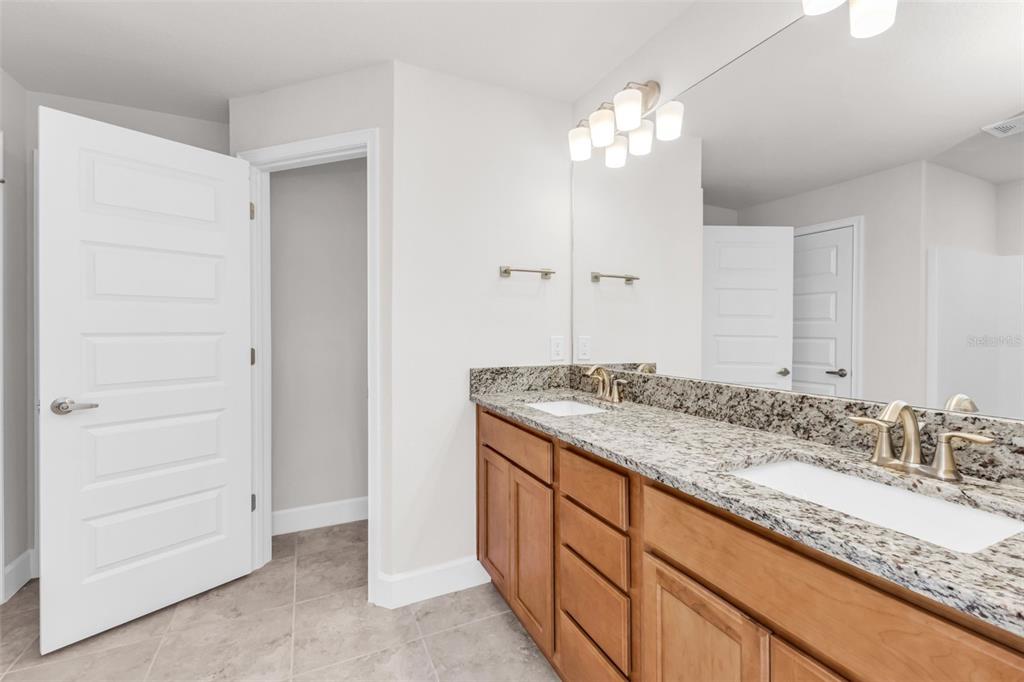 9500 Singer Circle Port Charlotte, FL 33981 - Photo 33 of 60 a bathroom with a granite countertop sink and a mirror