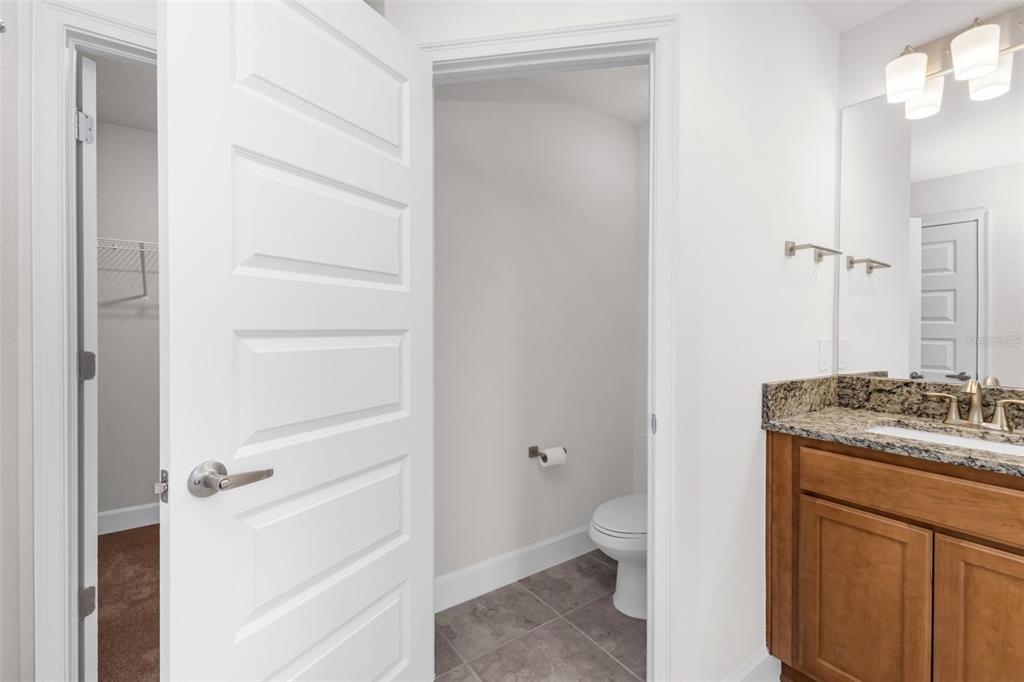 9500 Singer Circle Port Charlotte, FL 33981 - Photo 34 of 60 a bathroom with a granite countertop sink toilet and shower