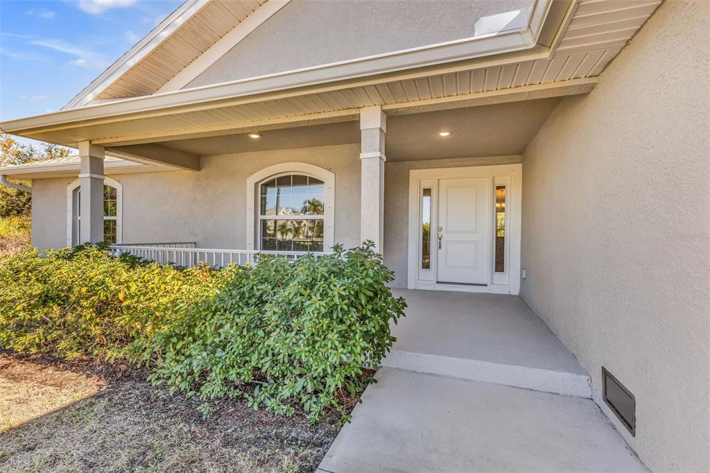 9500 Singer Circle Port Charlotte, FL 33981 - Photo 5 of 60 a front view of a house with a yard