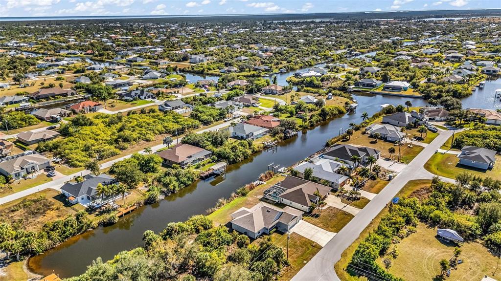 9500 Singer Circle Port Charlotte, FL 33981 - Photo 55 of 60 an aerial view of a house with a yard and lake view in back