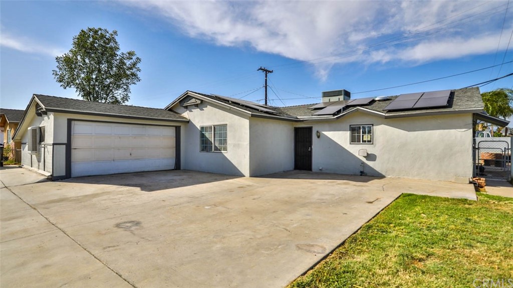 6307 Rustic Lane Riverside, CA 92509 - Photo 1 of 1 a front view of a house with a yard and garage