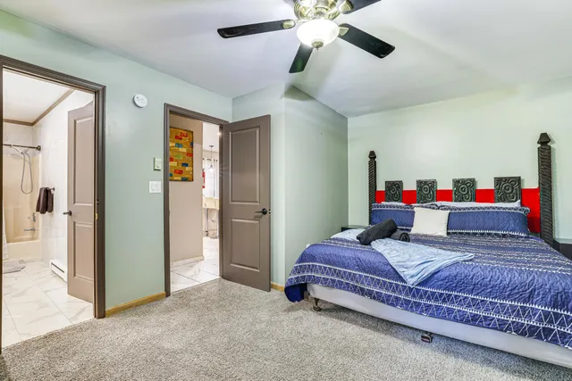 a bedroom with bed and a chandelier