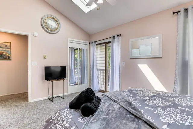 a bedroom with a bed and a television