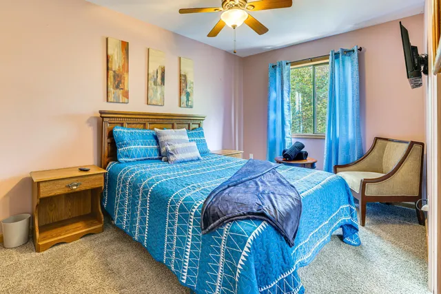 a bedroom with a bed and a chandelier