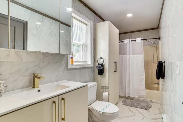 a bathroom with a sink toilet and shower