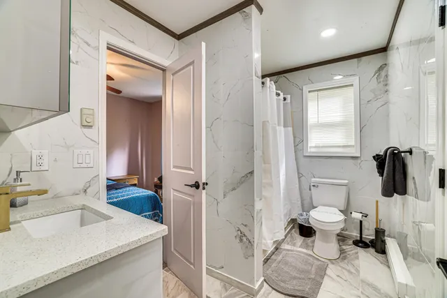 a bathroom with a sink toilet and shower