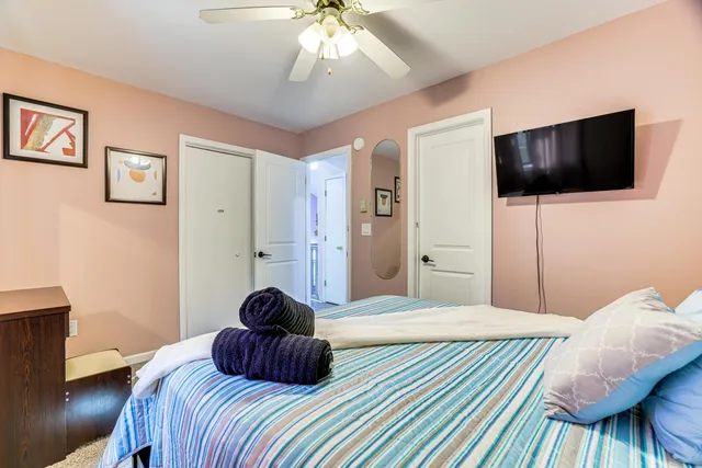 a bedroom with a bed and a chandelier