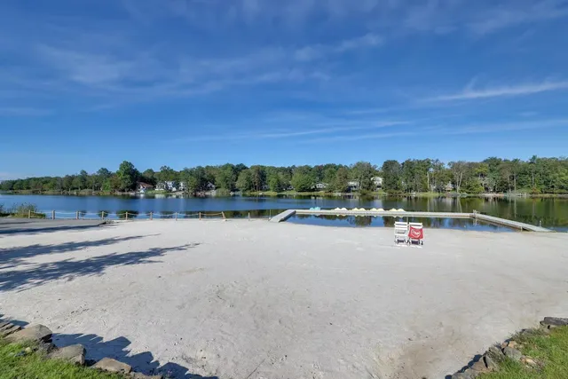 a view of a lake with beach and city view