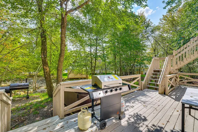 a view of a patio with table and chairs with wooden floor and fence