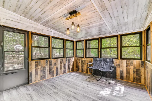 a view of a room with wooden floor and iron stairs
