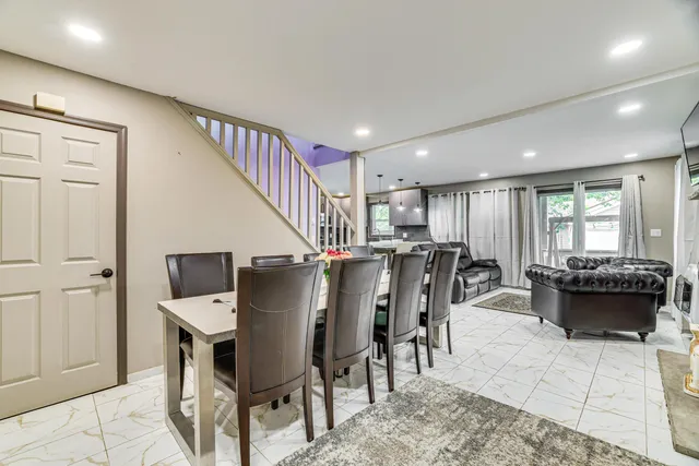 a dining room with furniture and entryway