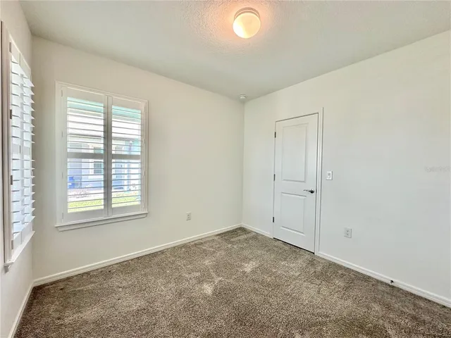 a spacious bathroom with a double vanity sink mirror and shower