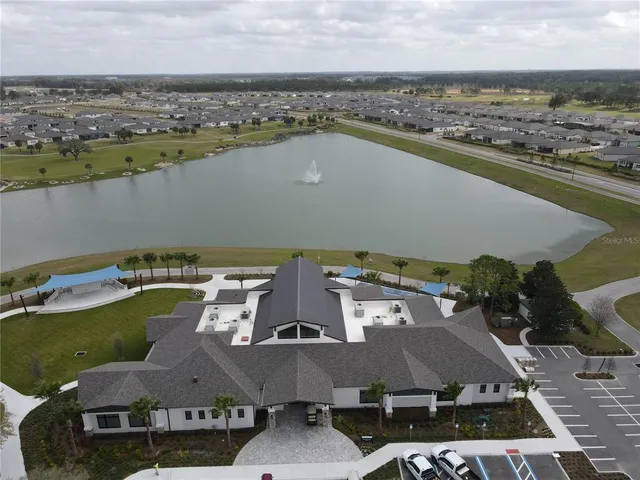 an aerial view of a residential houses with outdoor space and seating