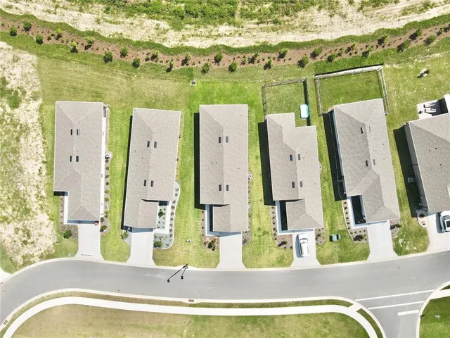 swimming pool view with a garden and seating space