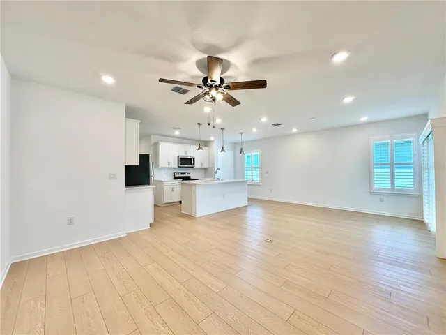 a view of kitchen with cabinets and wooden floor