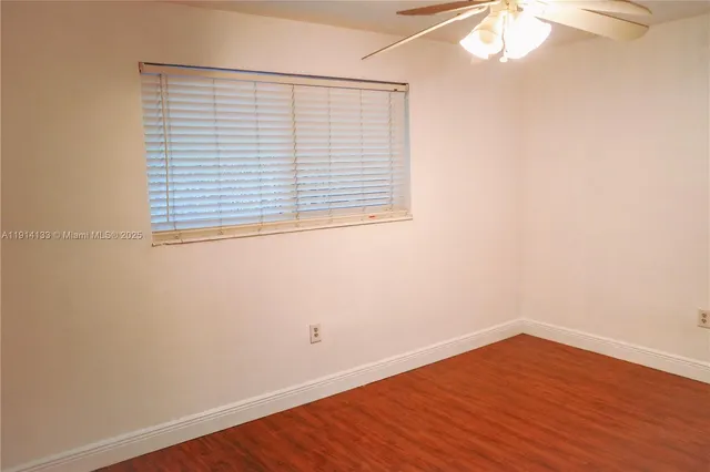 an empty room with wooden floor