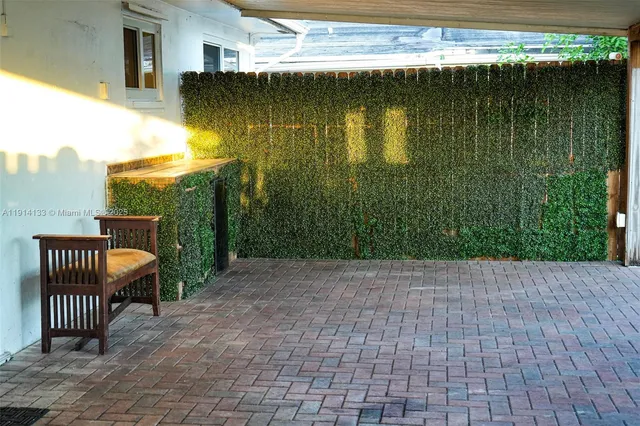 a view of a backyard with sitting area