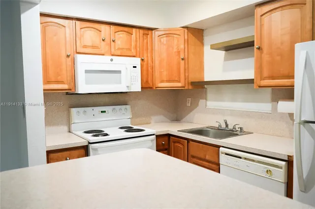a kitchen with stainless steel appliances granite countertop a sink stove and a refrigerator