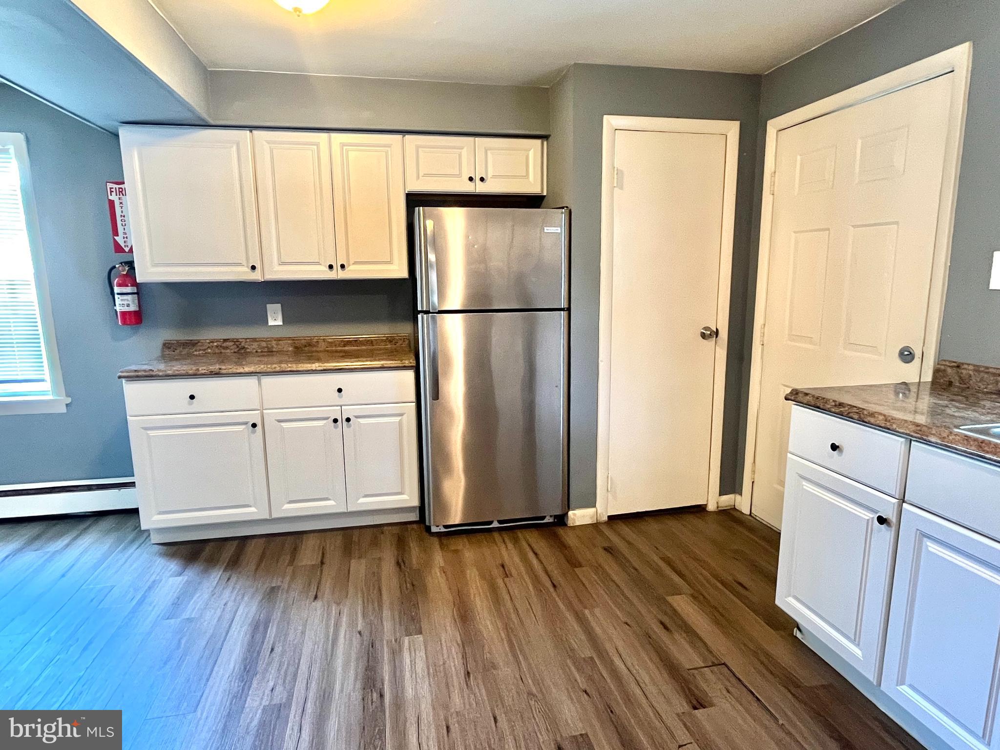 140 East Federal Street Burlington, NJ 08016 - Photo 11 of 18 a kitchen with granite countertop wooden floors and white stainless steel appliances