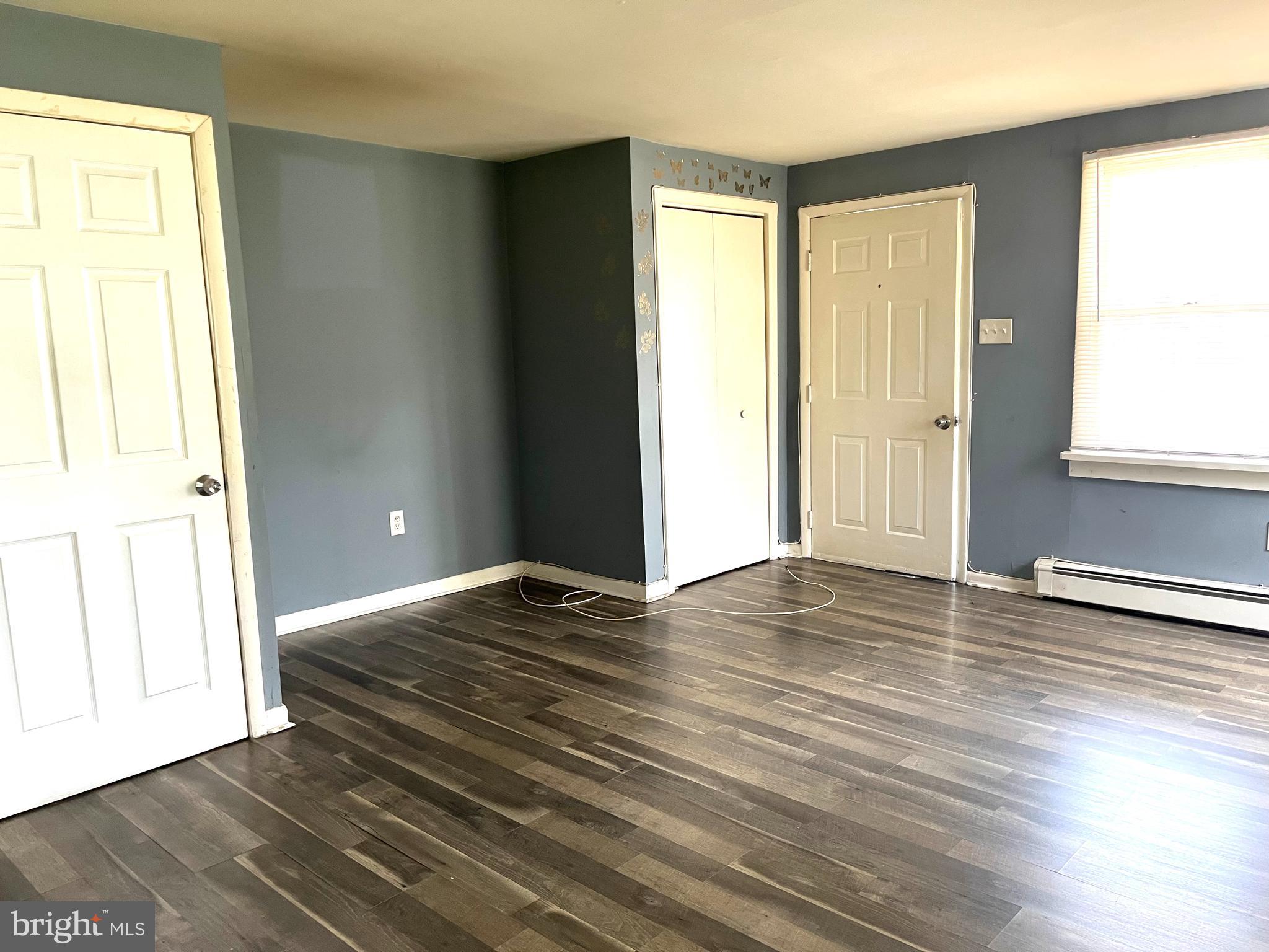 140 East Federal Street Burlington, NJ 08016 - Photo 3 of 18 an empty room with wooden floor and windows