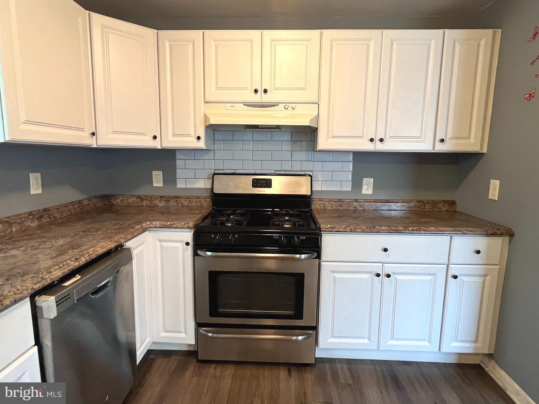 140 East Federal Street Burlington, NJ 08016 - Photo 8 of 18 a kitchen with granite countertop white cabinets and a stove