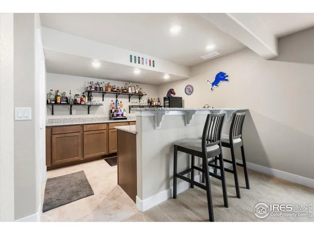 a kitchen with kitchen island a stove a table and chairs in it