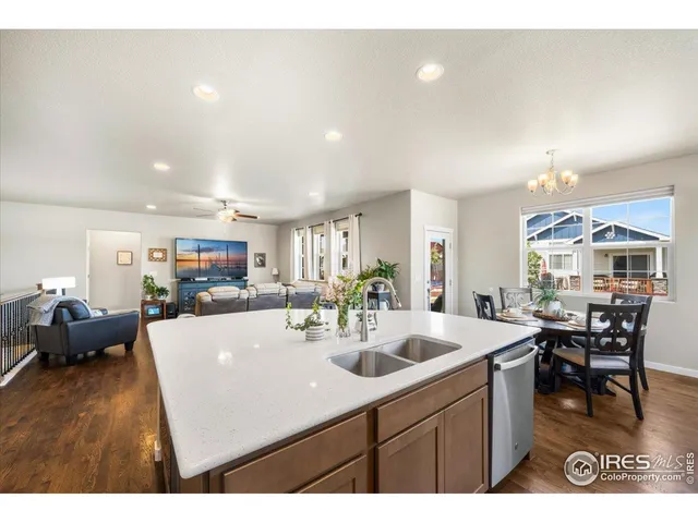 a kitchen with sink and view of living room